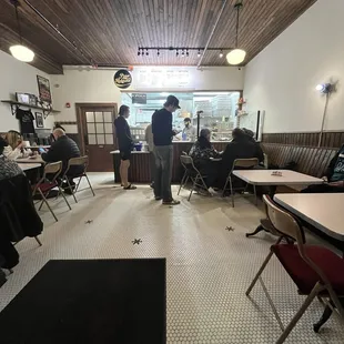 people sitting at tables in a restaurant