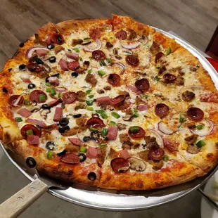 Supreme NY style pizza - half w/o ham and black olives per our request