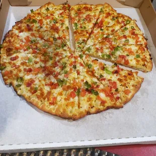 White Bianca sauce pizza either tomatoes, green peppers and roasted red peppers