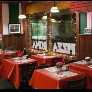 tables and chairs with red tablecloths
