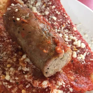 Half eaten...Pizza sausage. In hindsight I think I maybe was supposed to wrap the square bread around the sausage... i didn&apos;t know