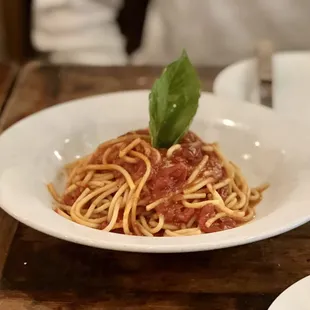 a plate of spaghetti with tomato sauce