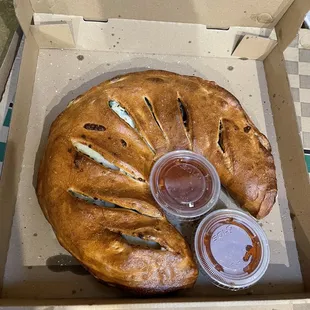 Fresh spinach calzone- again- HUGE! With two 4oz sauce containers