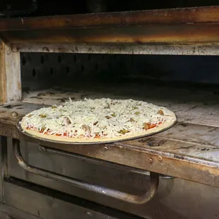 a pizza baking in an oven