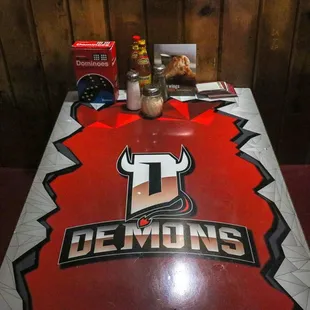 a table with a sign that says demons
