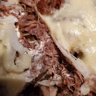 a piece of meat and cheese pizza