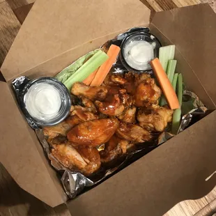 chicken wings and carrots in a box