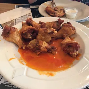 a plate of chicken wings and sauce
