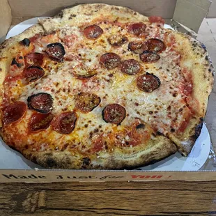 a pepperoni pizza in a box