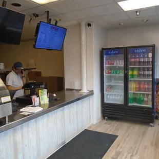 Main desk and soda cooler.