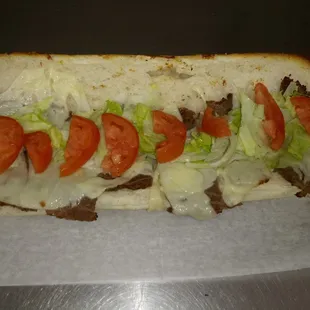 a sandwich with tomatoes and lettuce