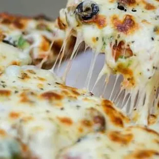 a slice of pizza being lifted by a spatula