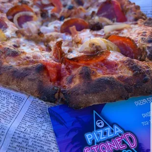 a slice of pizza on a newspaper