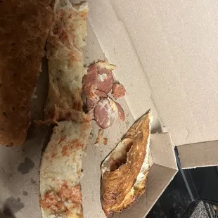 a half eaten pizza in a box