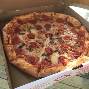 Large pepperoni and mushroom pizza.