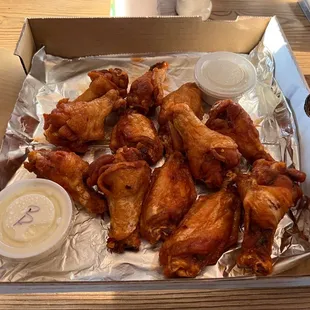 a box of chicken wings and dipping sauce