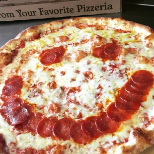 a pepperoni pizza on a table
