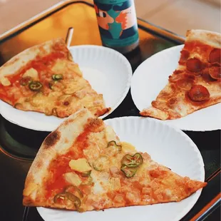 three slices of pizza on plates