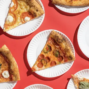 slices of pizza on paper plates