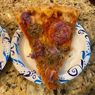 Pepperoni,sausage,red onion and tomato pizza