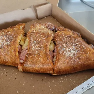 a half eaten pizza in a box