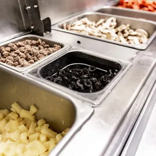 a variety of toppings in a buffet