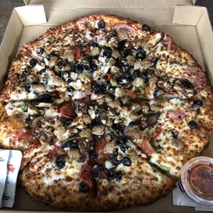 a pizza in a box with toppings