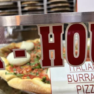 a sign for a house pizza