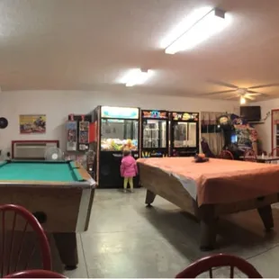 a pool table and arcade machines