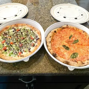 two pizzas on a table