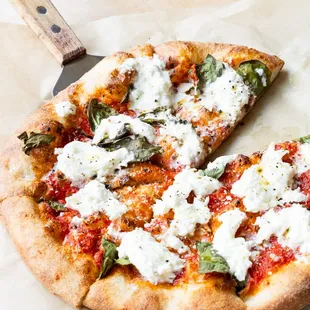 Salted Burrata pie, topped with fresh Burrata and farm-fresh basil. A staff-favorite vegetarian pie!