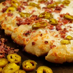 Jalapeno Bacon Sticks: our homemade dough topped with sea salt, jalapenos, bacon and mozzarella cheese.
