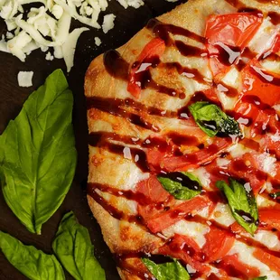 Caprese: extra virgin olive oil, fresh mozzarella, fresh tomatoes, sea salt, fresh basil, balsamic glaze.