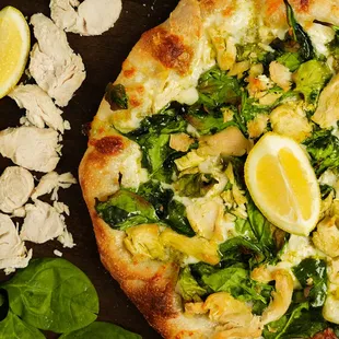 Chicken Lemon Pesto: basil pesto, mozzarella, roasted chicken, spinach, parmesan, fresh lemon.