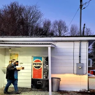 a man standing in front of a vending machine