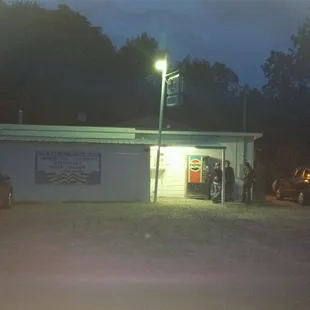 a group of people standing outside of a restaurant