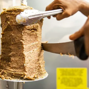 a person cutting a cake with a knife