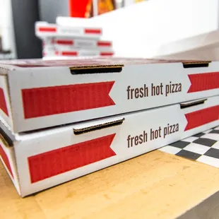 two boxes of fresh hot pizza