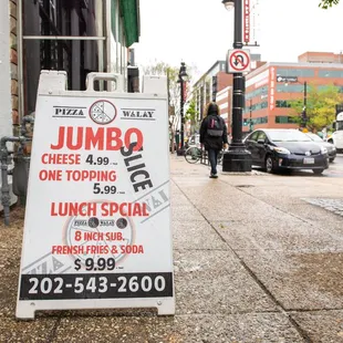 a jumbo sign on a sidewalk