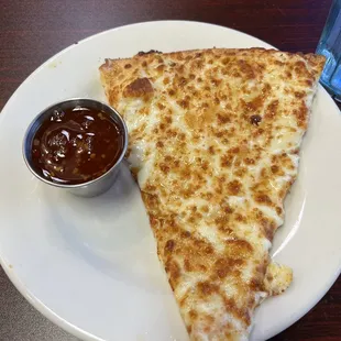 The slice of Crab Rangoon Pizza. Very bland and crust undercooked. The sweet chili sauce was super spicy. No balance.