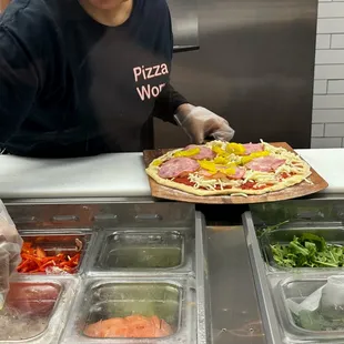 a woman making a pizza