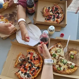 a group of people eating pizza