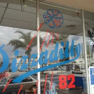 the front window of a pizza parlor