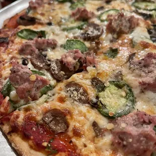 Sausage, jalapeño, and mushroom thin crust pizza
