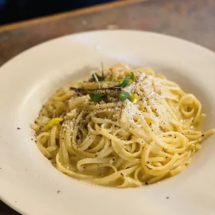 a plate of pasta with parmesan cheese