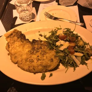 Chicken Milanese, served with a side salad.