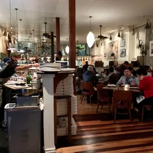 people sitting at tables in a restaurant