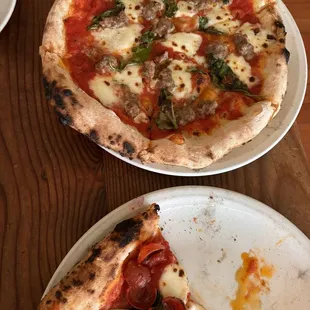 Margherita pizzas. One with pepperoni and the other with sausage