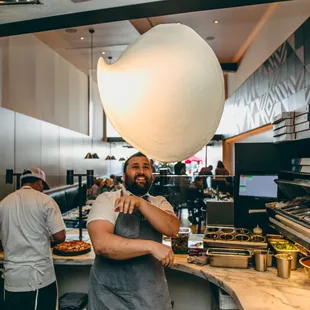 a man holding a large white ball above his head