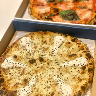 two pizzas in boxes